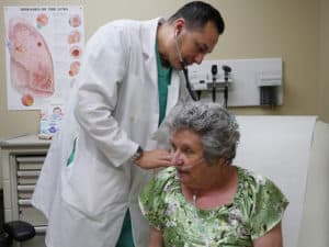 A Medical Assistant Examining a Patient